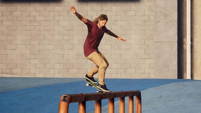 A skateboarder in a red shirt grinds on a rail