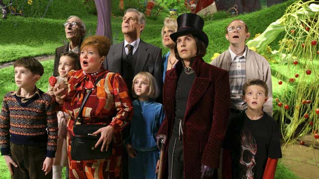 Willy Wonka stands with the chocolate factory guests. 