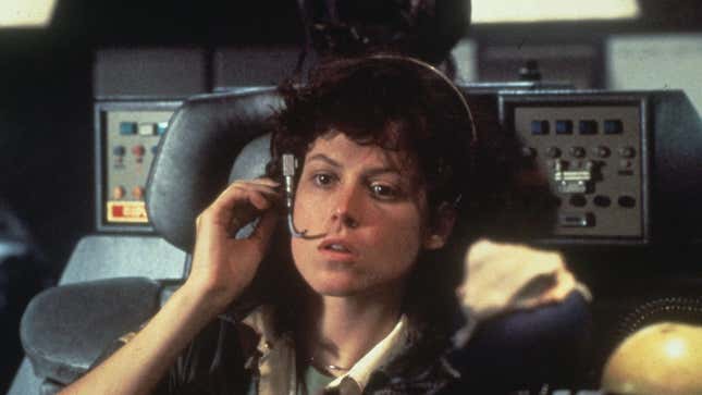 Ripley sits in the cockpit of a spaceship. 