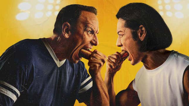 An image shows two men eating hot dogs. 